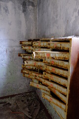 An old broken mailbox in an apartment building.