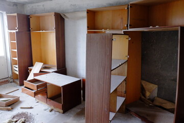 Obraz na płótnie Canvas Broken wooden cabinets in an abandoned room. Old Soviet furniture in an abandoned apartment in Pripyat.