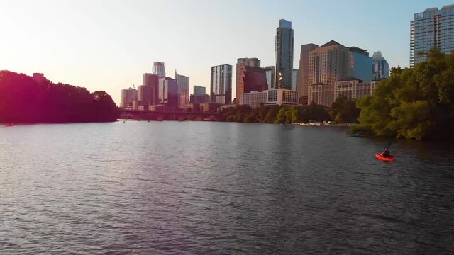 Flyby of a Kayaker Paddling towards Downtown Austin Texas. Shot at golden hour, august 2020