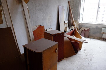 Old furniture strewn about a room in an abandoned apartment in the ghost town of Pripyat.