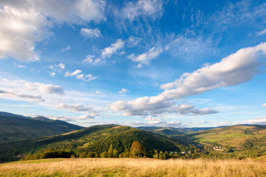 beautiful carpathian countryside. sunny afternoon. wonderful autumn landscape in mountains. rural scenery with agricultural fields on rolling hills. watershed ridge in the distance