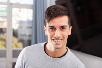 Portrait of stylish young man in living room. High quality photo