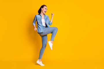 Fototapeta na wymiar Full length photo of ecstatic girl look good copyspace enjoy rejoice lucky lottery win raise fists scream yeah isolated over shine color background