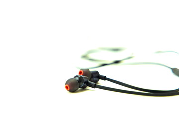 Naklejka premium Black earphones for listening to music or speak on the phone. Isolated on white background