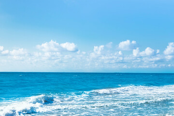 Ocean water with blue sky with clouds.