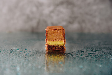Chocolate cake cut on a mirror surface