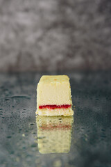 Chocolate cake cut on a mirror surface