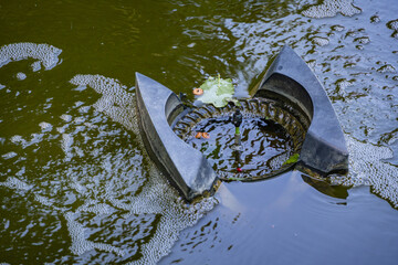 Skimmer Messner floats onsurface of water in a pond. Close-up. Clean pond. Skimmer collects leaves,...