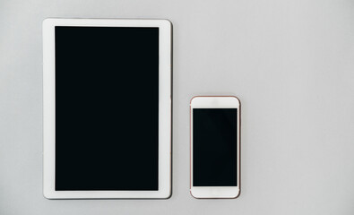 Digital tablet and mobile phone isolated on gray background stock photo 