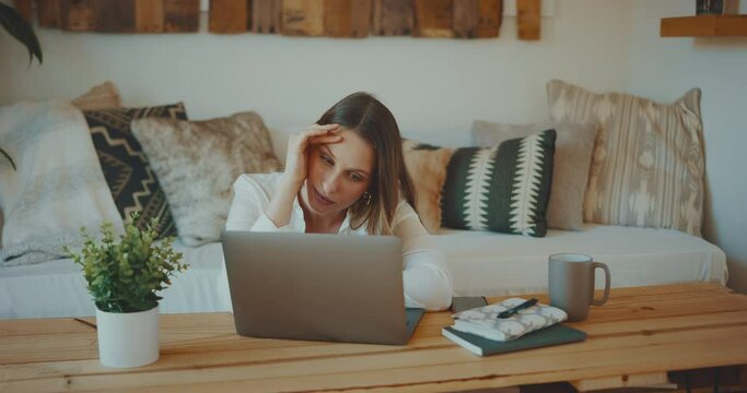 Professional young woman feeling defeated while working from home, remote work concept