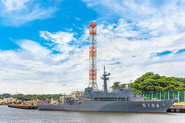 yokosuka, japan - july 19 2020: Oceanographic research ship JS Shonan AGS-5106 of the Japan Maritime Self-Defense Force berthed in front of a signal tower of the Yokosuka Naval Port.