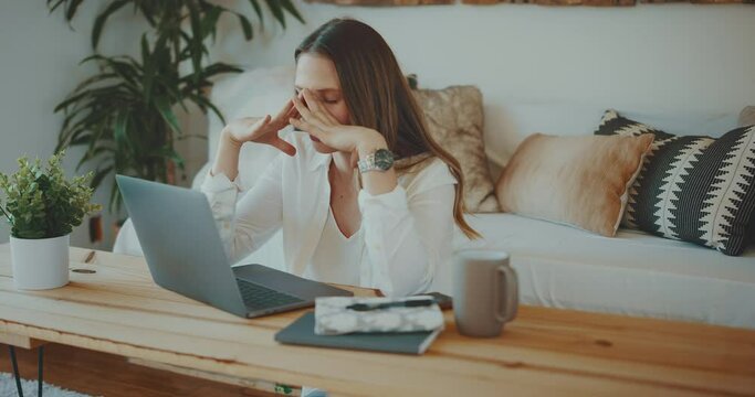 Professional young woman feeling defeated while working from home, remote work concept