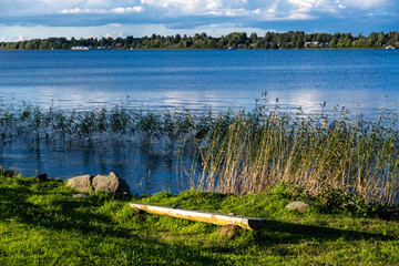 view of a large beautiful lake against the backdrop of clouds and blue sky