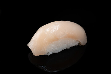 One Japanese fresh Sushi nigiri with scallop on black background, close up © Andrey