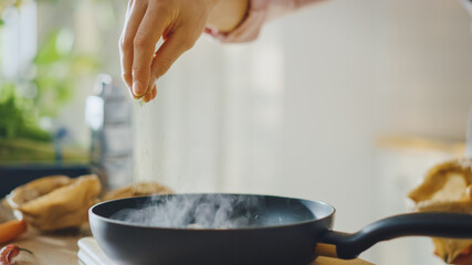 Close Up Shot of a Person Preparing a Healthy Vegetarian Meal on a Frying Pan. Cooking Healthy Green Food in a Modern Kitchen. Natural Clean Diet and Healthy Way of Life Concept.
