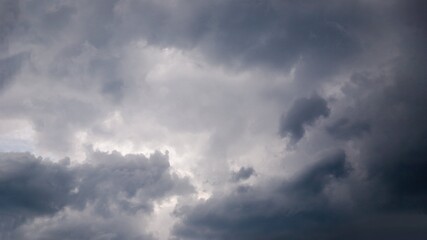 Naklejka na ściany i meble Dramatic gray clouds in the sky. Dark gray cloudy sky, panorama