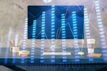 Double exposure of chart and financial info and work space with computer background. Concept of...