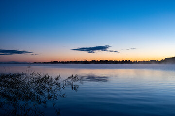 morning haze rises over the lake at sunrise