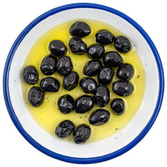 Black olives with olive oil in a large plate, isolated on white background. Top view.