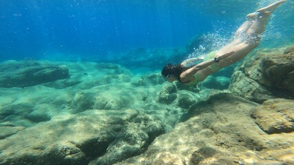Fototapeta na wymiar young woman snorkelling in costa brava