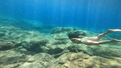 young woman snorkelling in costa brava