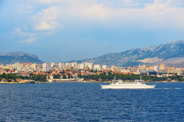 Fototapeta na wymiar Split City Harbor from upper deck of large sea ferry boat. Sea, passenger ship, city skyline with mountains.