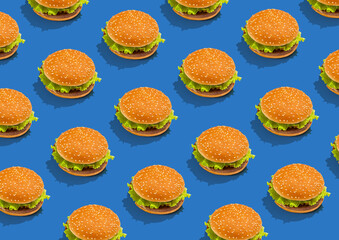 Tasty fresh hamburgers with lettuce and sesame bun on blue background