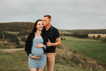 Beautiful pregnant woman and her husband. A couple of happy people. selective focus