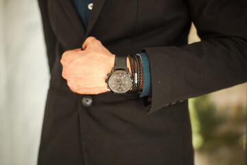 businessman holding a watch