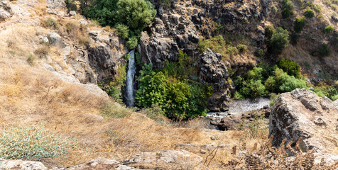 The Dvora  waterfall on the shallow mountain river Jelabun with crystal clear water in the Golan Heights in northern Israel
