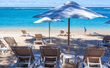 beach chairs and umbrellas, l’Hermitage, Saint-Gilles-Les-Bains, Reunion Island 