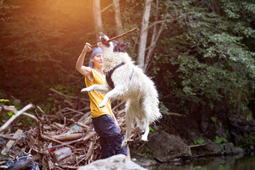 Woman playing with her dog in the forest
