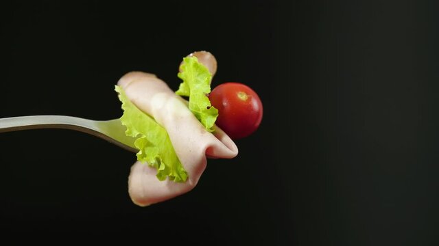 Forchetta con fetta di mortadella , lattuga e pomodorino
