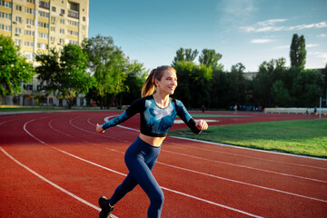 Fototapeta premium Woman running on treadmill in stadium