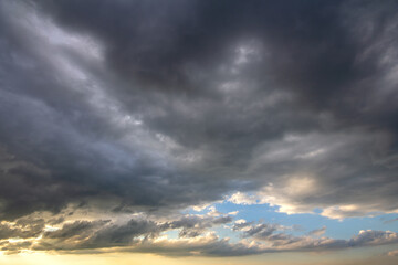 Sunset sky covered with dramatic storm puffy clouds before rain.
