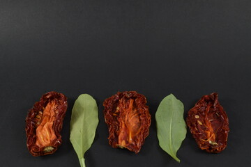 some dried tomatoes on a black background