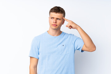 Fototapeta premium Young handsome man over isolated white background making the gesture of madness putting finger on the head