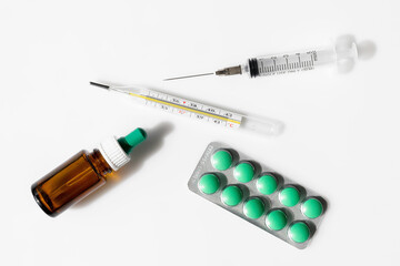 Thermometer, pills, nasal drops and syringe