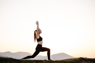 Fototapeta na wymiar Woman balanced, practicing meditation, zen energy yoga in mountains. Healthy lifestyle concept. Young girl doing fitness exercise sport outdoors. Morning sunrise. Relax in nature.