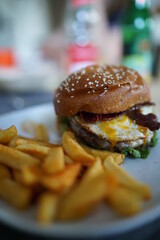 Burger with barbecue sauce eggs Bacon and fries