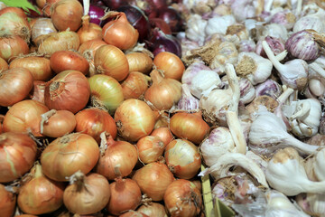 Full frame photo of white onion and garlic bulbs.