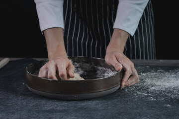 Obraz na płótnie Canvas Hands preparing bread dough, kneading the dough. Hands with flour splash, food homemade bakery concept