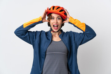 Young cyclist woman isolated on white background with surprise expression
