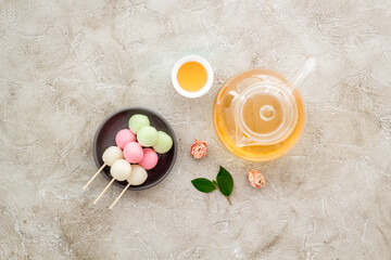 Japanese food background with sweets and tea. Three colored dumplings Dango