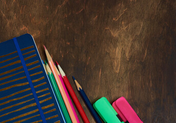 Multi-colored pencils on a wooden table