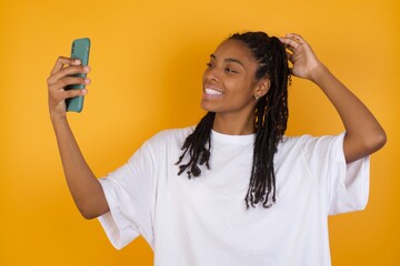 Photo of  Young dark skinned woman with braids hair wearing casual clothes trendy isolated over...