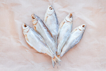 Dried fishes template banner on craft paper background with empty space for text. Flat Salted roach...