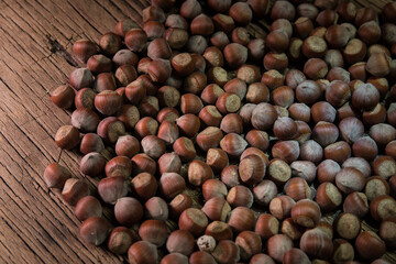 Still life with Walnut kernels and whole walnuts on rustic old wooden table. Creative table decoration.
