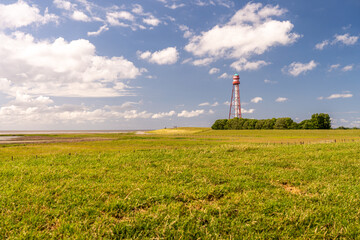view on the lighthouse of campen near emden, north sea, germany