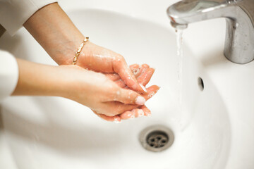 woman washing hands in bathroom